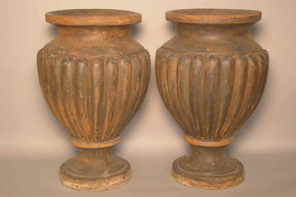 Appraisal: PAIR OF COMPOSITE CLASSICAL-FORM URNS For outdoor use the globular