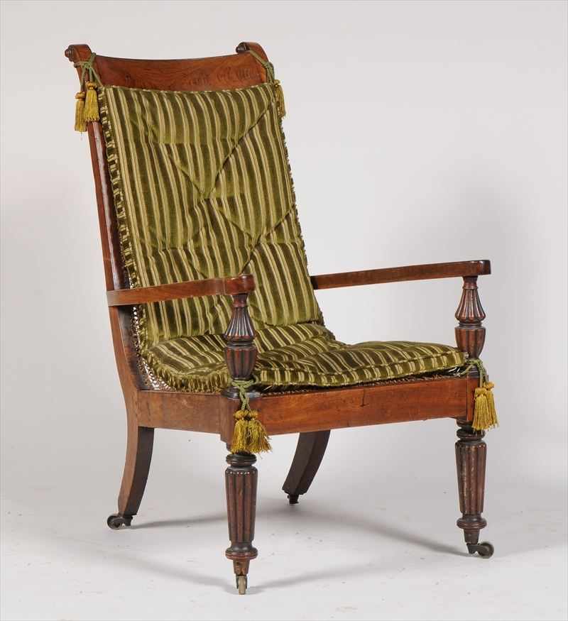 Appraisal: ANGLO-INDIAN TEAK AND CANED ARMCHAIR The concave cresting above a