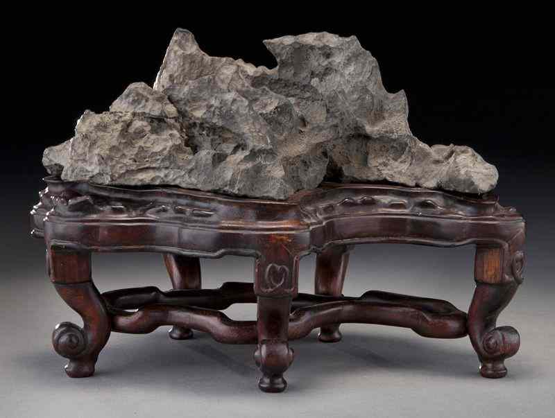 Appraisal: Chinese carved scholar stone raised on a hardwood stand ''H