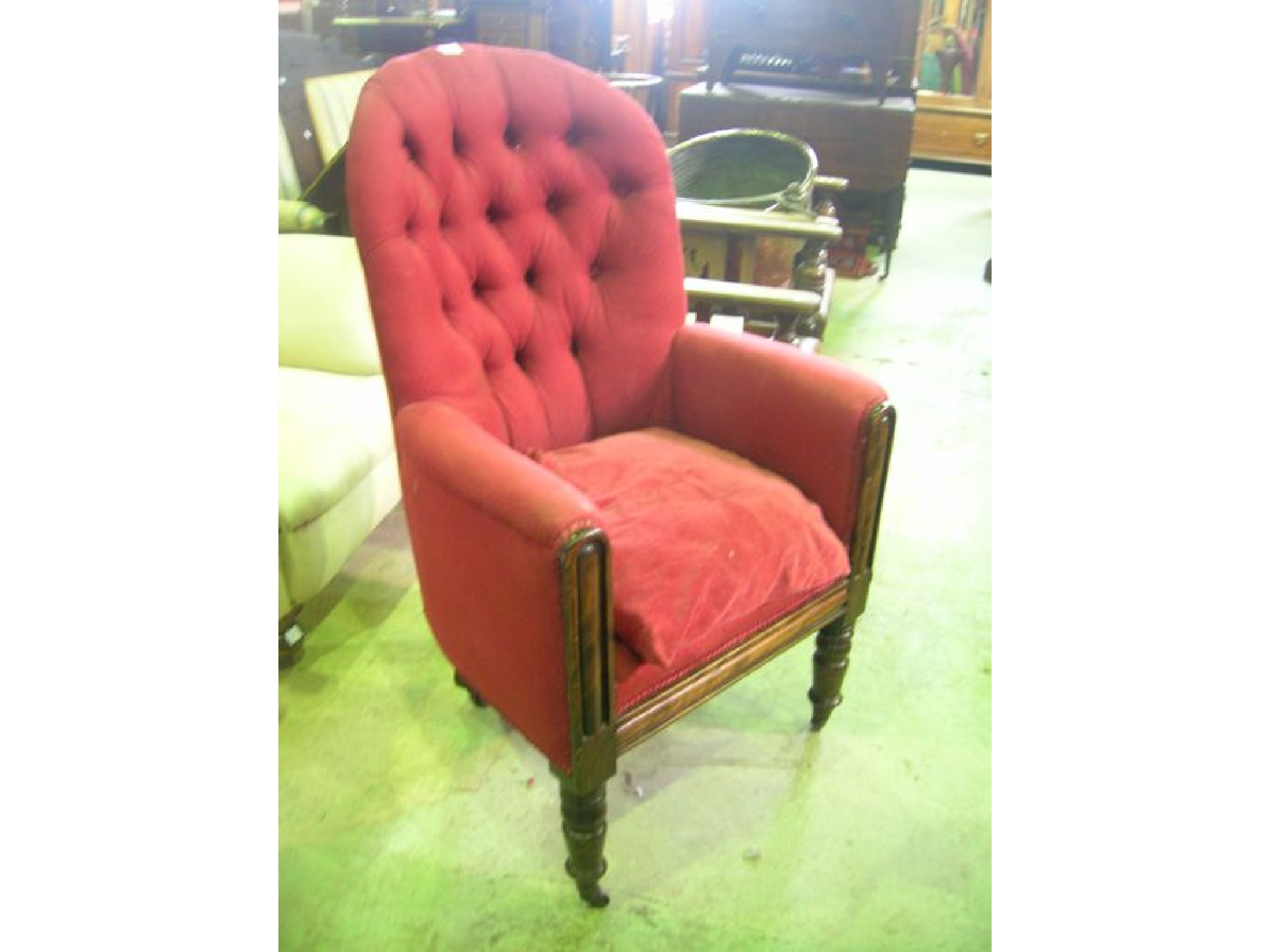 Appraisal: A Victorian spoonback armchair with upholstered finish and button back