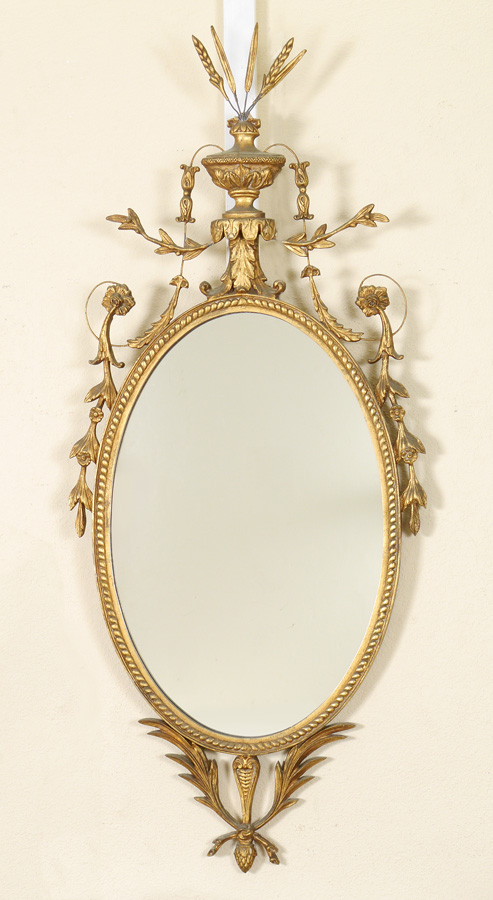 Appraisal: FRENCH CARVED GILT WOOD OVAL WALL MIRROR Frame with urn