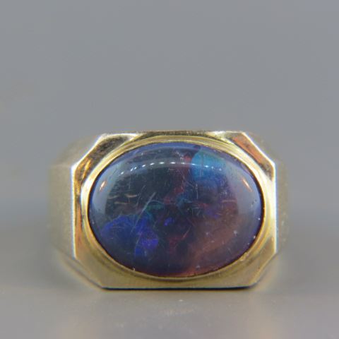 Appraisal: Black Opal Man's Ring fiery oval cabachon gem weighing carats