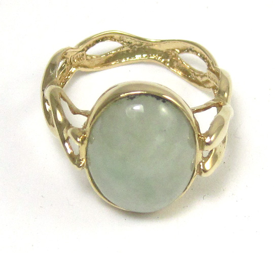 Appraisal: JADE AND FOURTEEN KARAT GOLD RING with a bezel set