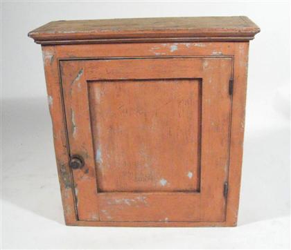 Appraisal: Salmon-painted hanging cupboard pennsylvania circa With molded cornice above a