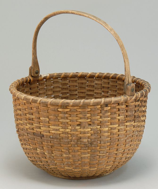 Appraisal: NANTUCKET-STYLE SWING-HANDLED BASKET Late th CenturyWith wooden bottom Height Diameter