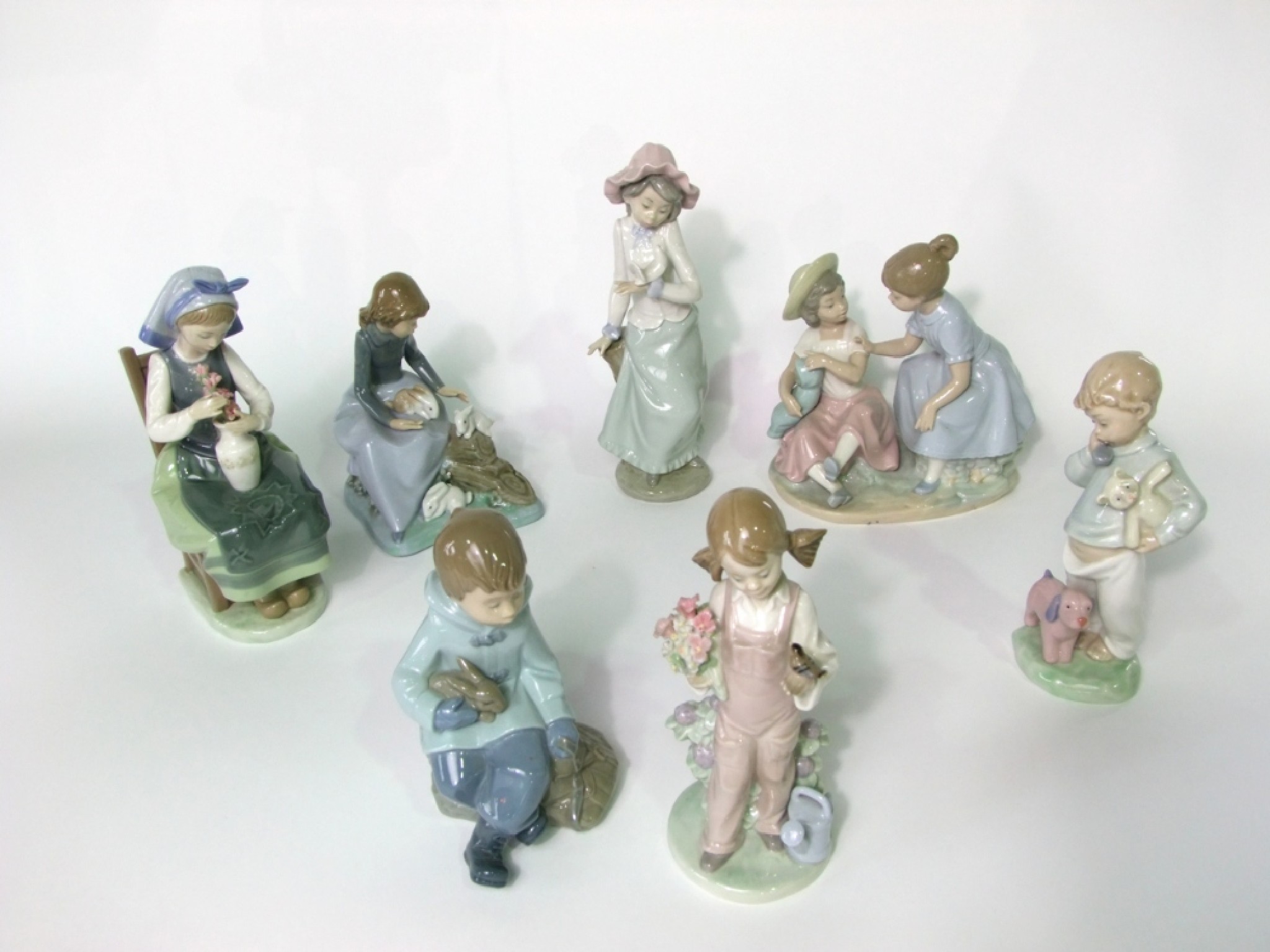 Appraisal: A collection of seven Nao and Lladro figure groups all