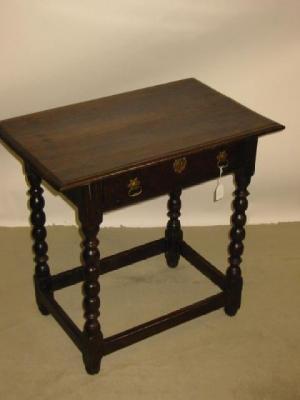 Appraisal: AN OAK SIDE TABLE with moulded edged plank top frieze