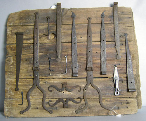 Appraisal: Mounted group of wrought iron hardware to include strap hinges