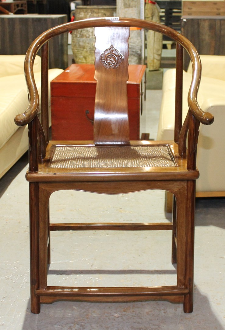 Appraisal: A th century hardwood horseshoe back chair with rattan seat