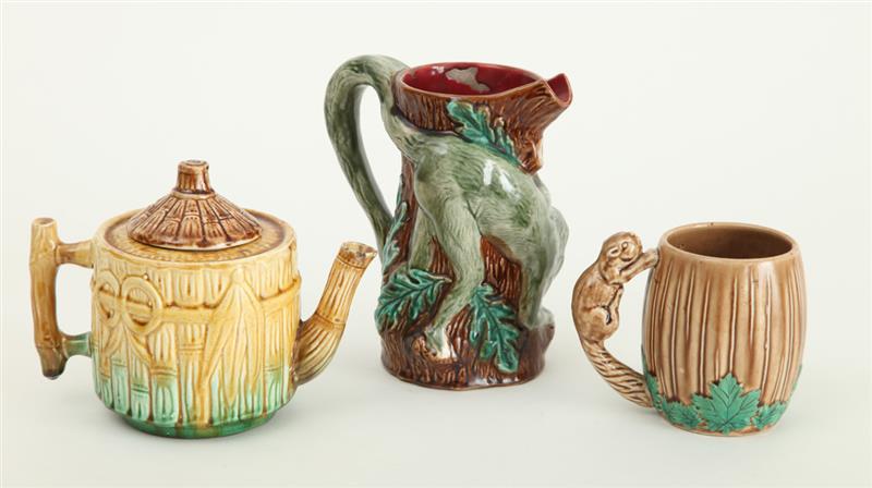 Appraisal: FRENCH MAJOLICA MONKEY-CLIMBING-ON-TRUNK PITCHER AND TWO OTHER MAJOLICA PITCHERS The