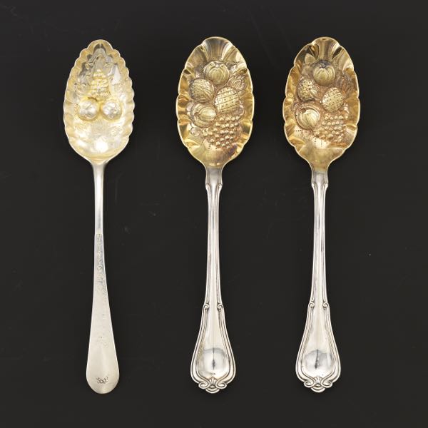 Appraisal: THREE STERLING BERRY SPOONS Two Gorham berry spoons with gold