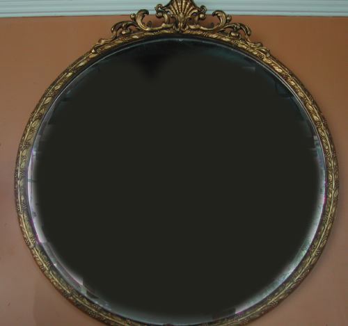 Appraisal: Large Circular Carved and Antiqued Giltwood Looking Glass in the