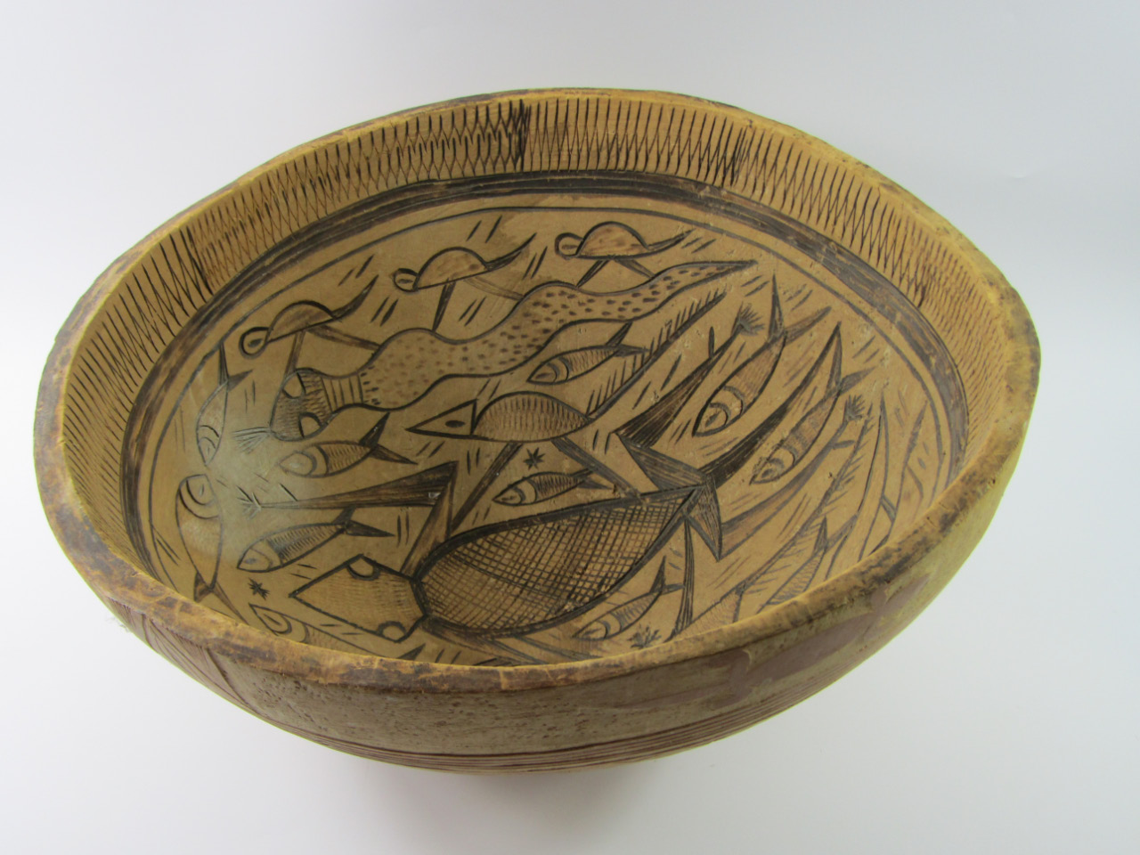 Appraisal: An ethnographic wooden bowl carved with animals turtle fish and