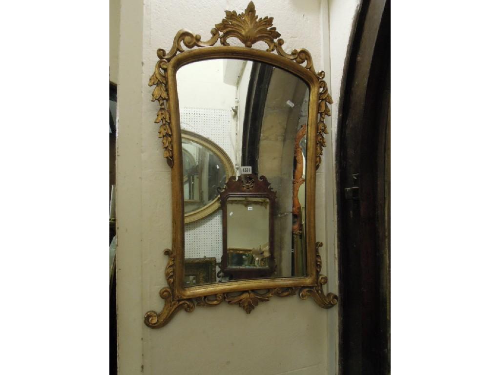 Appraisal: A decorative wall mirror of arched and waisted form with