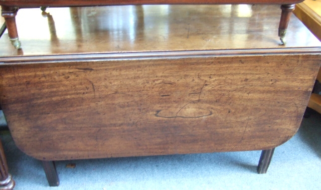 Appraisal: A George III mahogany drop flap dining table raised on