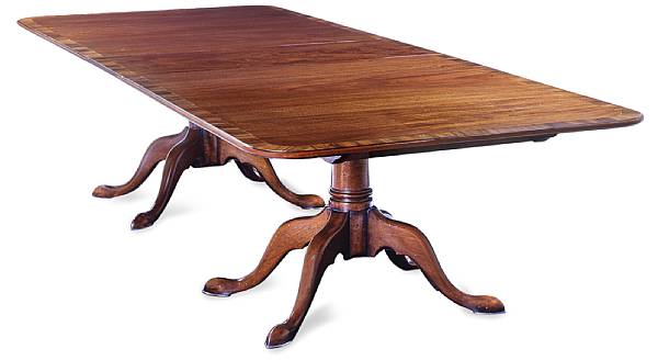 Appraisal: A Georgian style mahogany dining table The rectangular crossbanded top