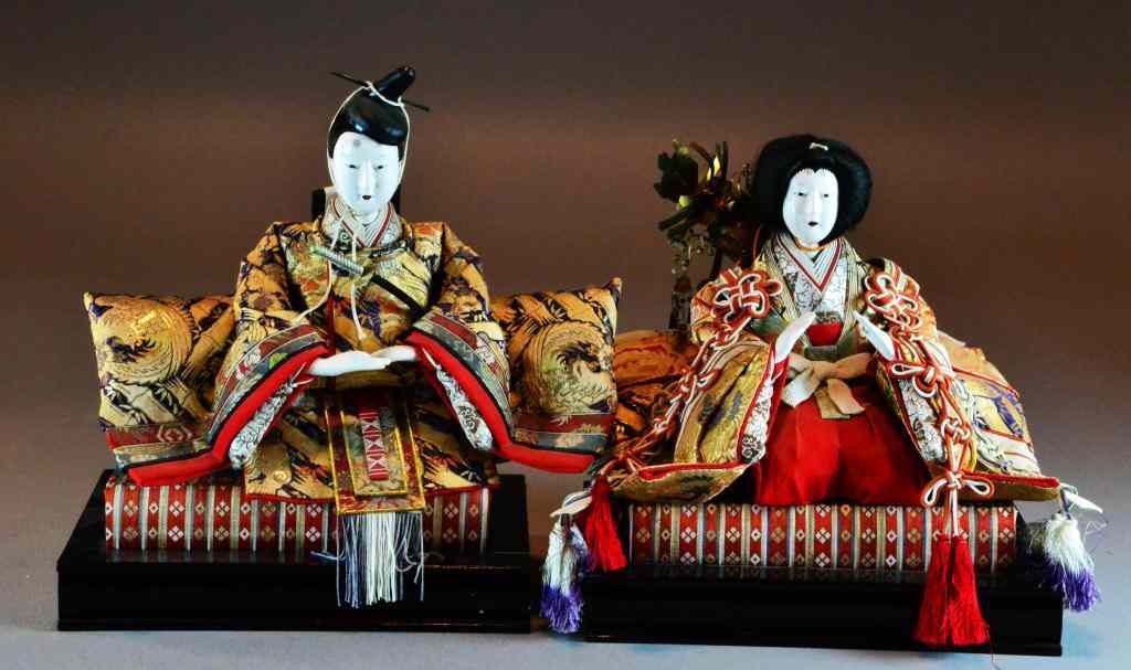 Appraisal: Pair Japanese Painted Brocade DollsDepicting a Samuri and a Geisha