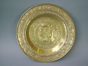 Appraisal: A Flemish brass alms dish the central reserve decorated with