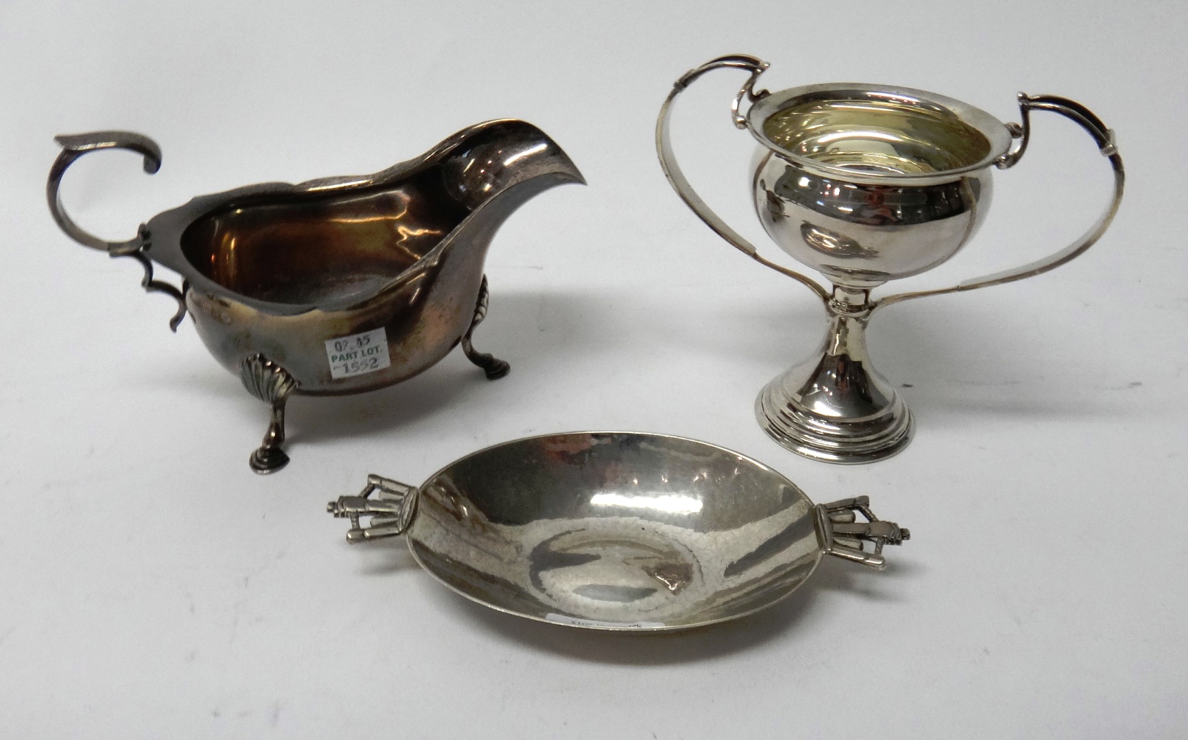 Appraisal: Silver comprising an oval twin handled dish the handles formed