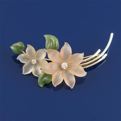 Appraisal: A gold floral brooch Mounted with two carved white stone