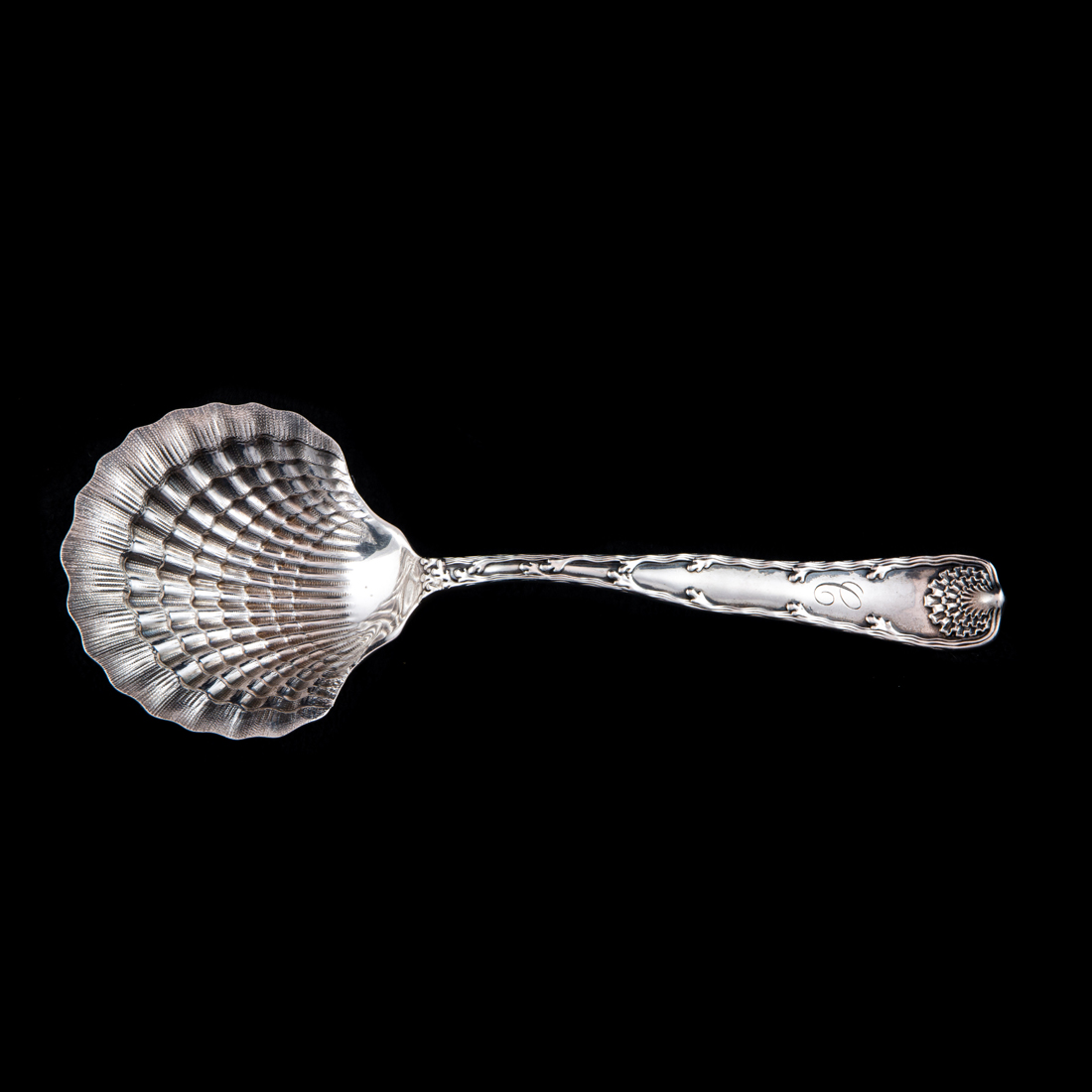 Appraisal: A TIFFANY WAVE EDGE STERLING BERRY SPOON WITH A SHELL