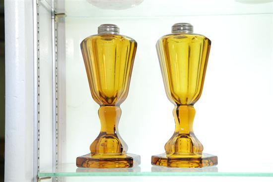 Appraisal: TWO AMBER GLASS KEROSENE LAMPS Both are paneled with metal