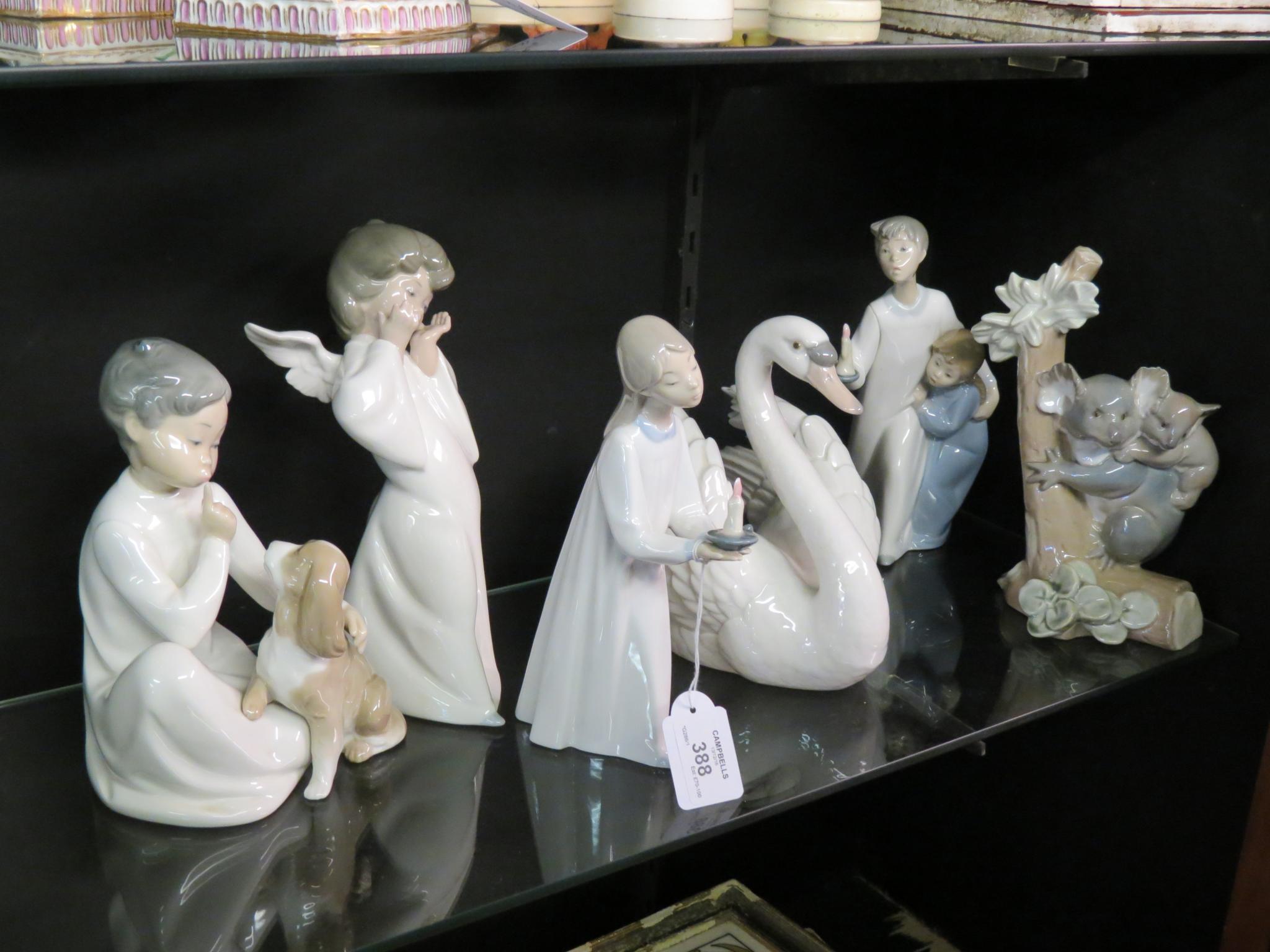 Appraisal: A group of four Lladro figures including cherub in a