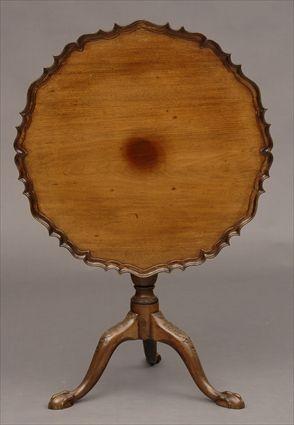 Appraisal: GEORGE II-STYLE CARVED MAHOGANY TILT-TOP TABLE The pie crust molded