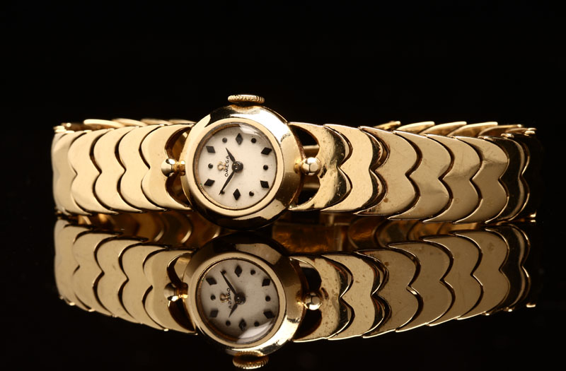 Appraisal: A ladies' Omega K yellow gold wristwatch Circular silvered dial