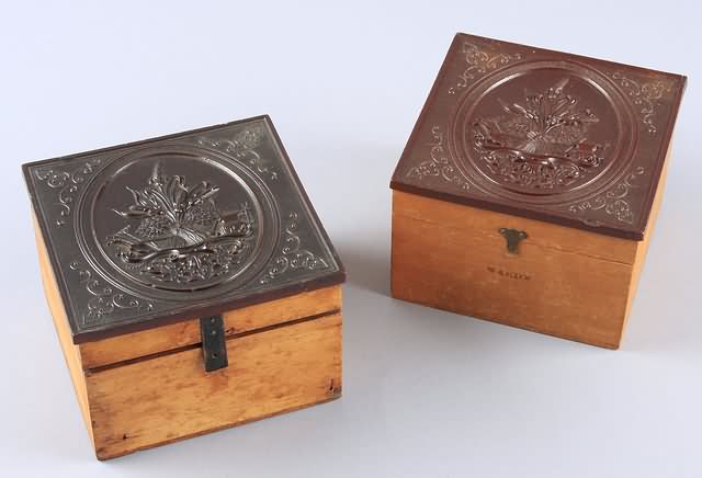 Appraisal: Pair of th century thermoplastic lidded collar boxes featuring agrarian