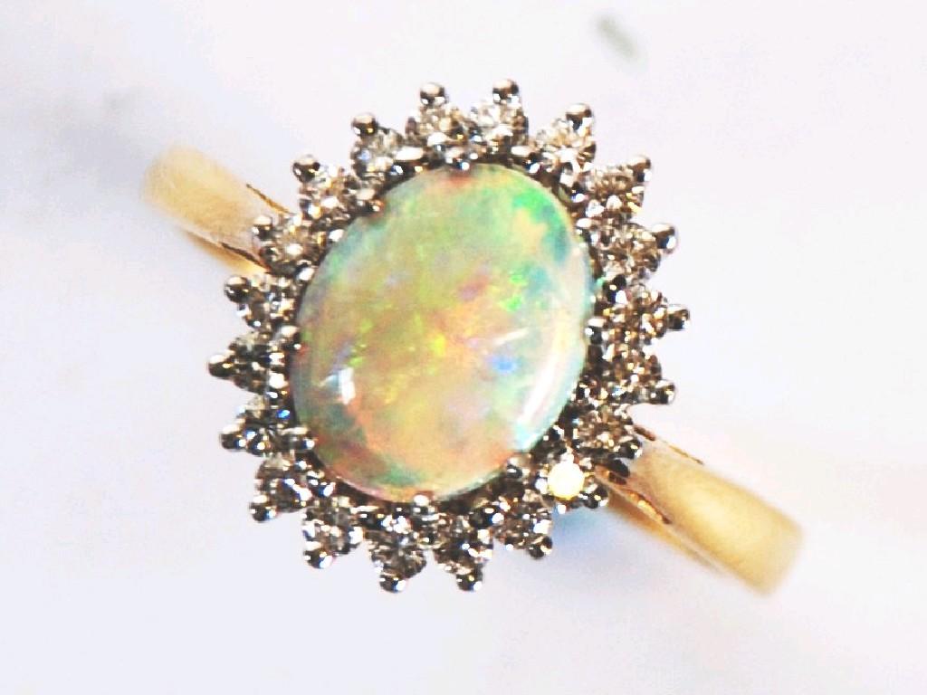 Appraisal: ct GOLD OPAL AND DIAMOND OVAL CLUSTER RING set with