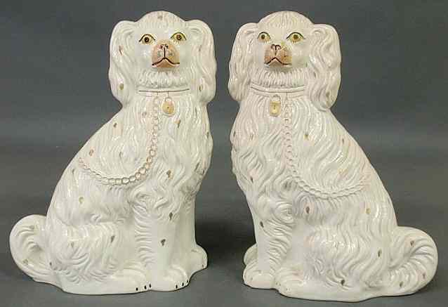 Appraisal: Pair of large th c Staffordshire seated white spaniels h