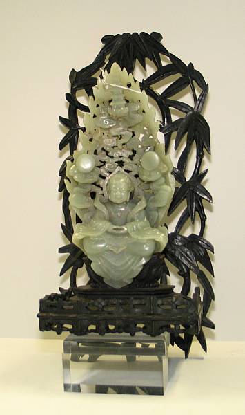 Appraisal: A nephrite carving of Buddha Portrayed seated in meditation in