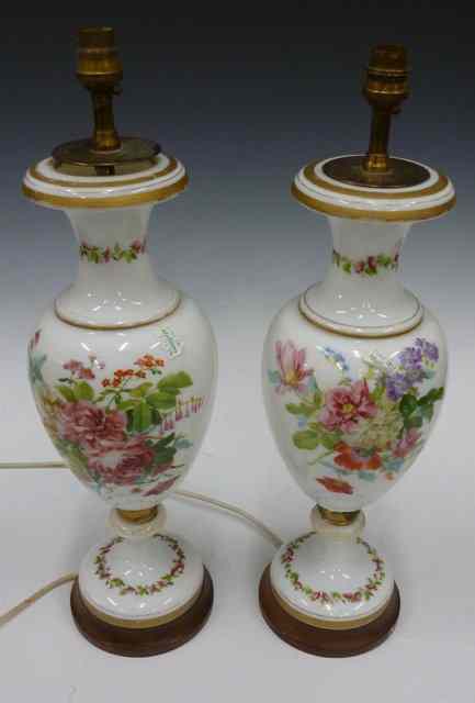 Appraisal: A PAIR OF CONTINENTAL WHITE GLASS DECORATED TABLE LAMPS of