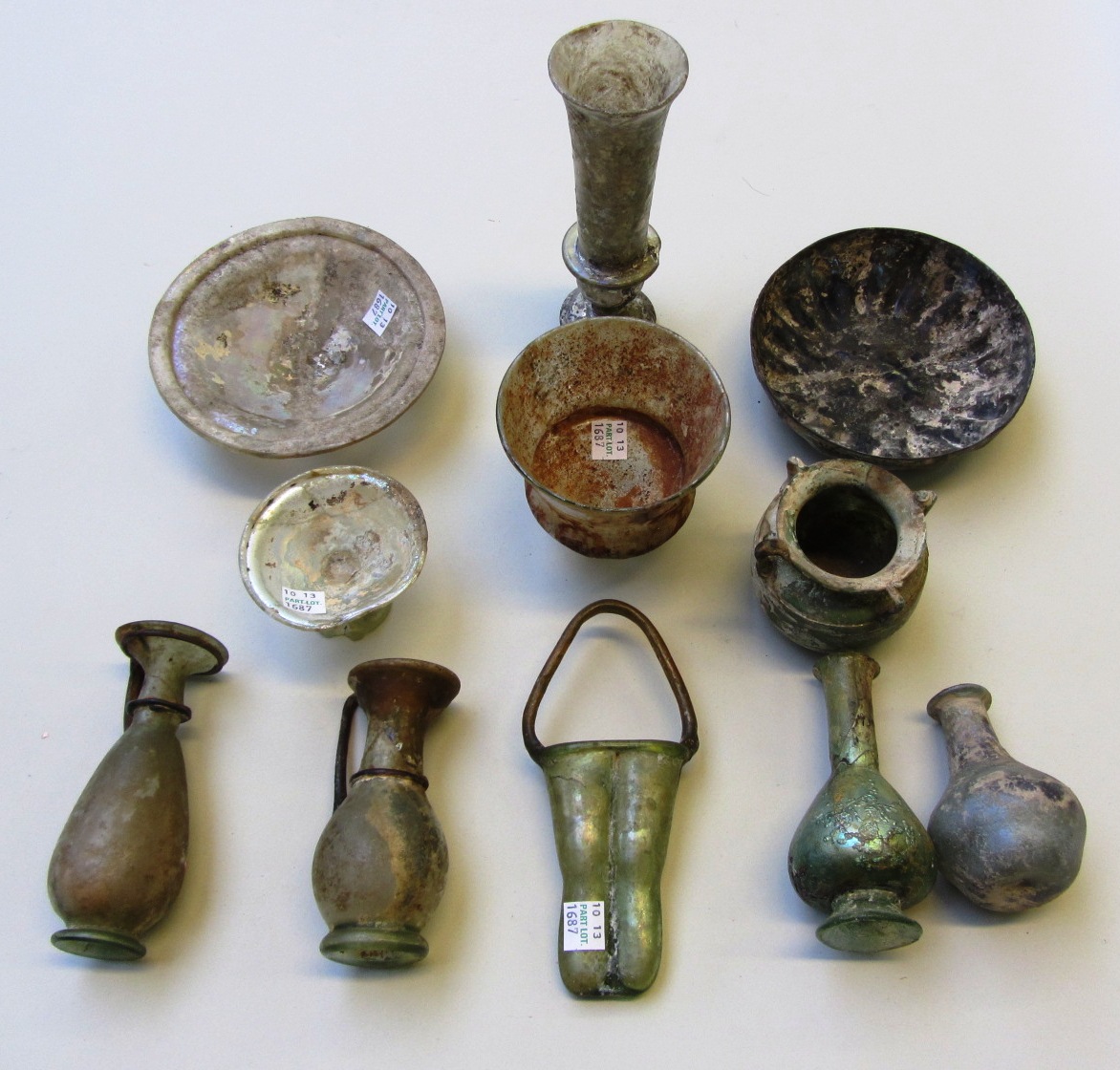 Appraisal: A group of Roman glass vessels mostly damaged and repaired