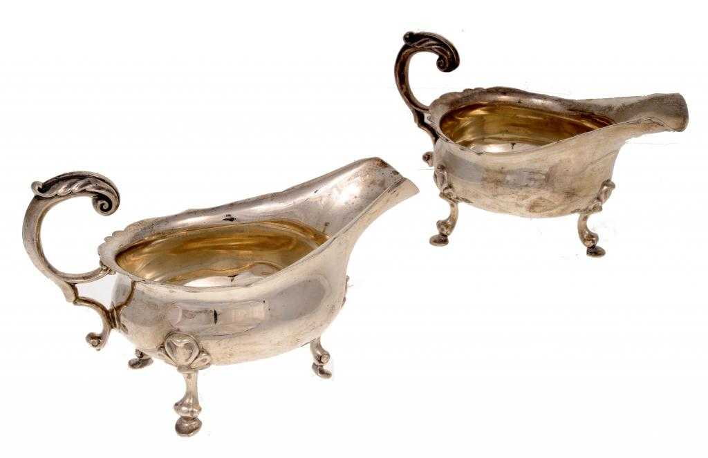 Appraisal: A PAIR OF GEORGE VI SAUCE BOATS with leaf capped