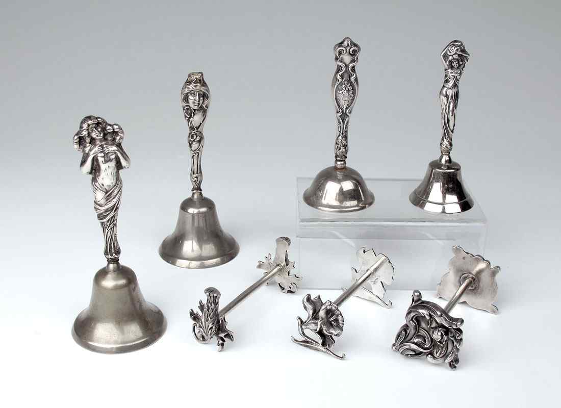 Appraisal: STERLING HANDLED BELLS STERLING KNIFE RESTS Bells with art nouveau