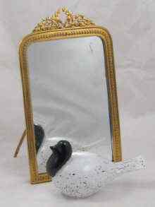 Appraisal: A strut back table mirror with gilt surround and wreath