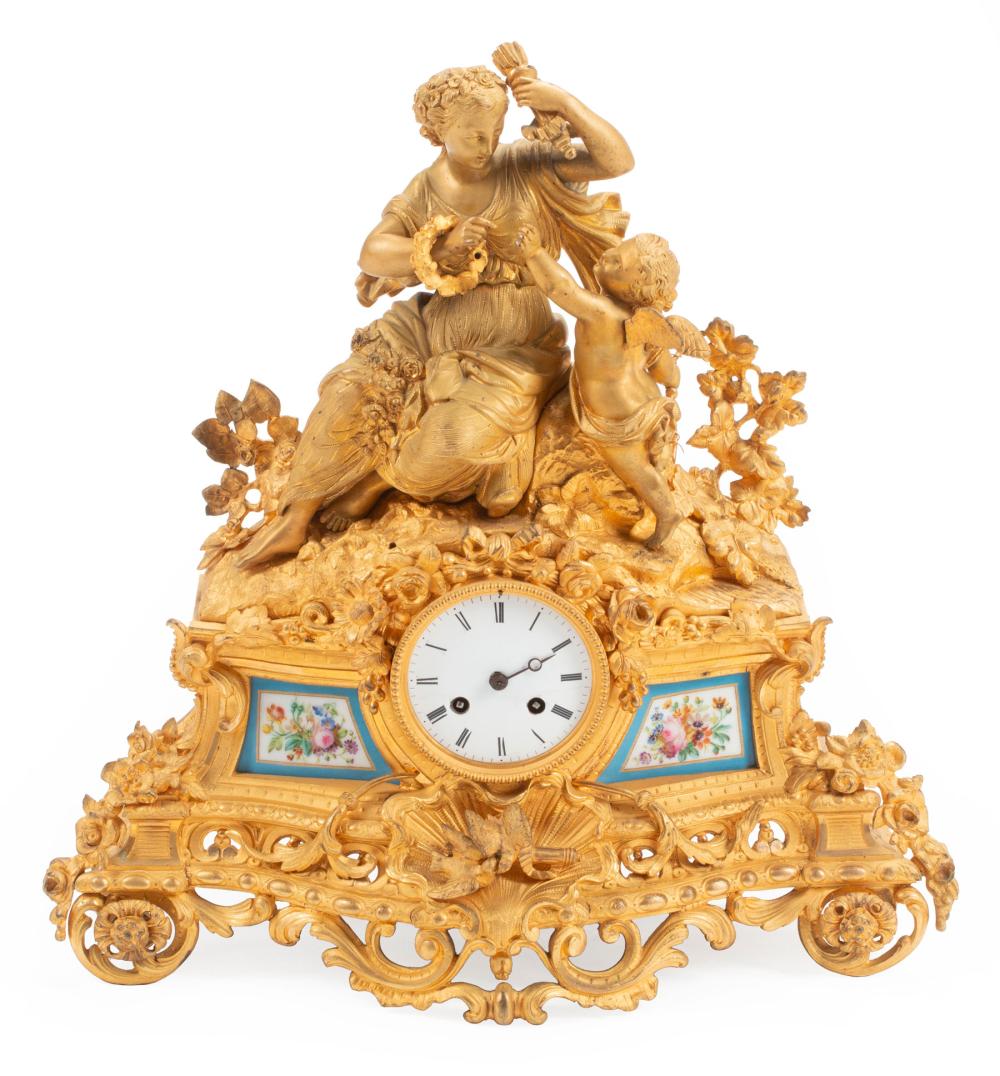 Appraisal: French Porcelain-Mounted Gilt Bronze Mantel Clock surmounted by a maiden