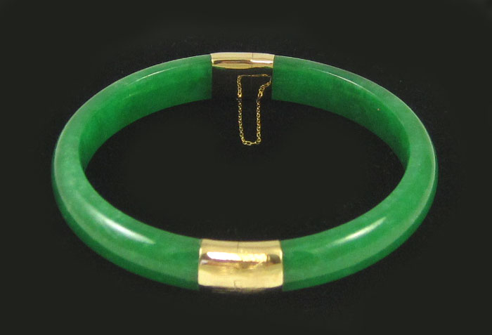 Appraisal: JADE AND FOURTEEN KARAT GOLD BANGLE the round hinged green