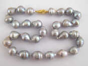 Appraisal: A Tahitian grey cultured pearl necklace with a yellow metal