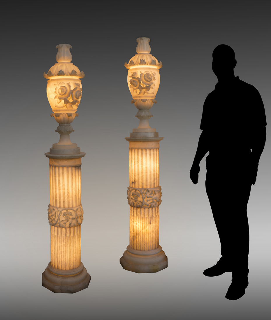 Appraisal: PAIR TH CENTURY ALABASTER LIGHTED URNS ON PEDESTALS Exquisite carved