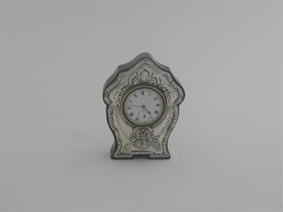 Appraisal: An Edwardian mounted timepiece with white enamel dial and black