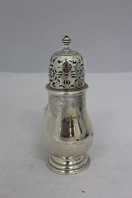 Appraisal: A SILVER SUGAR CASTOR with pierced top and a baluster