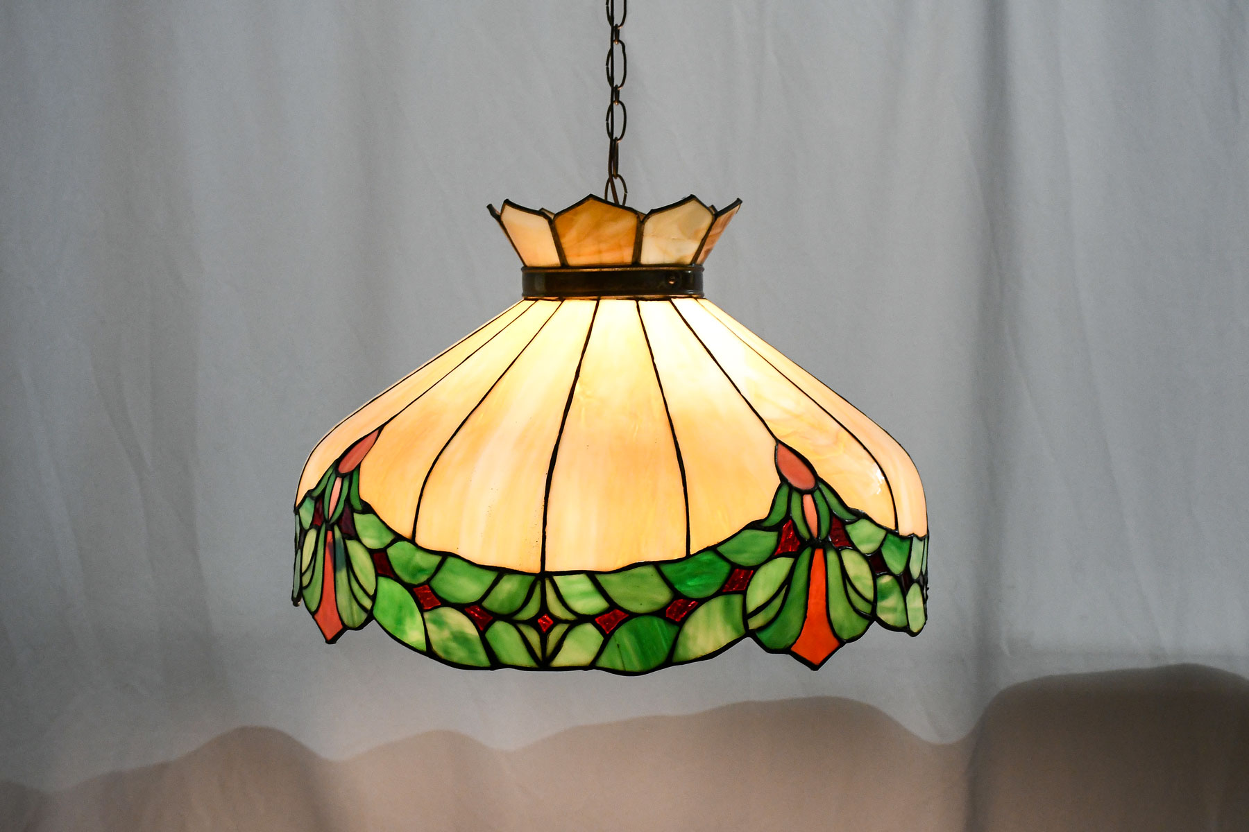 Appraisal: LARGE STAINED GLASS HANGING LAMP Caramel slag glass bent panels