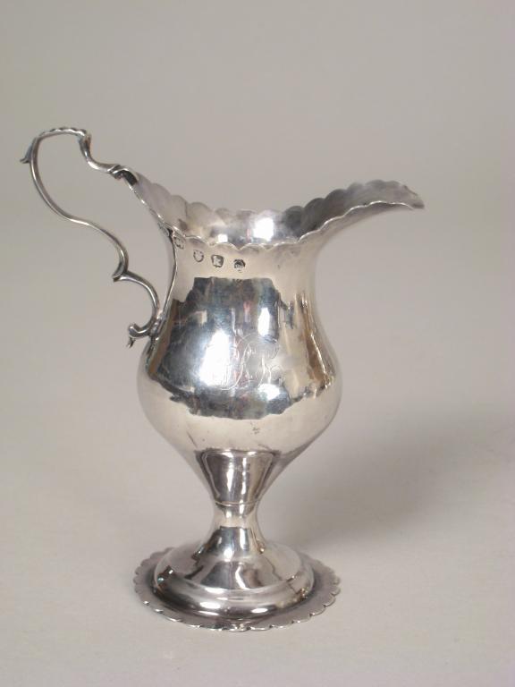 Appraisal: A George III pedestal Cream Jug engraved initials with shaped