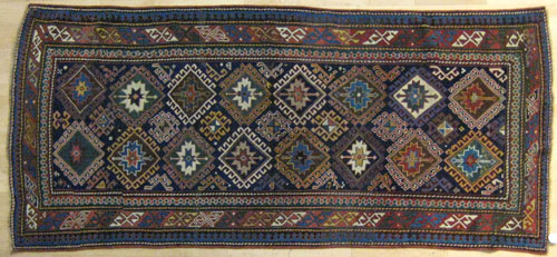 Appraisal: Kazak carpet ca with repeating medallions on a blue field