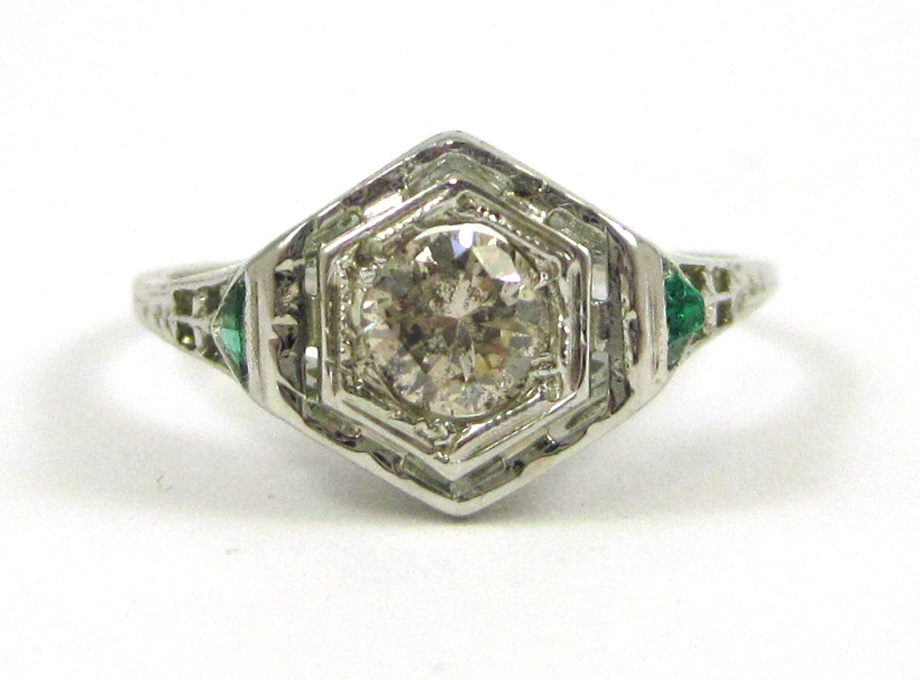 Appraisal: DIAMOND EMERALD AND EIGHTEEN KARAT GOLD RING The pierced white