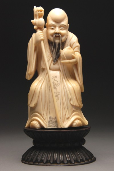 Appraisal: Solid ivory seated figure of Shou Lau with dragon staff