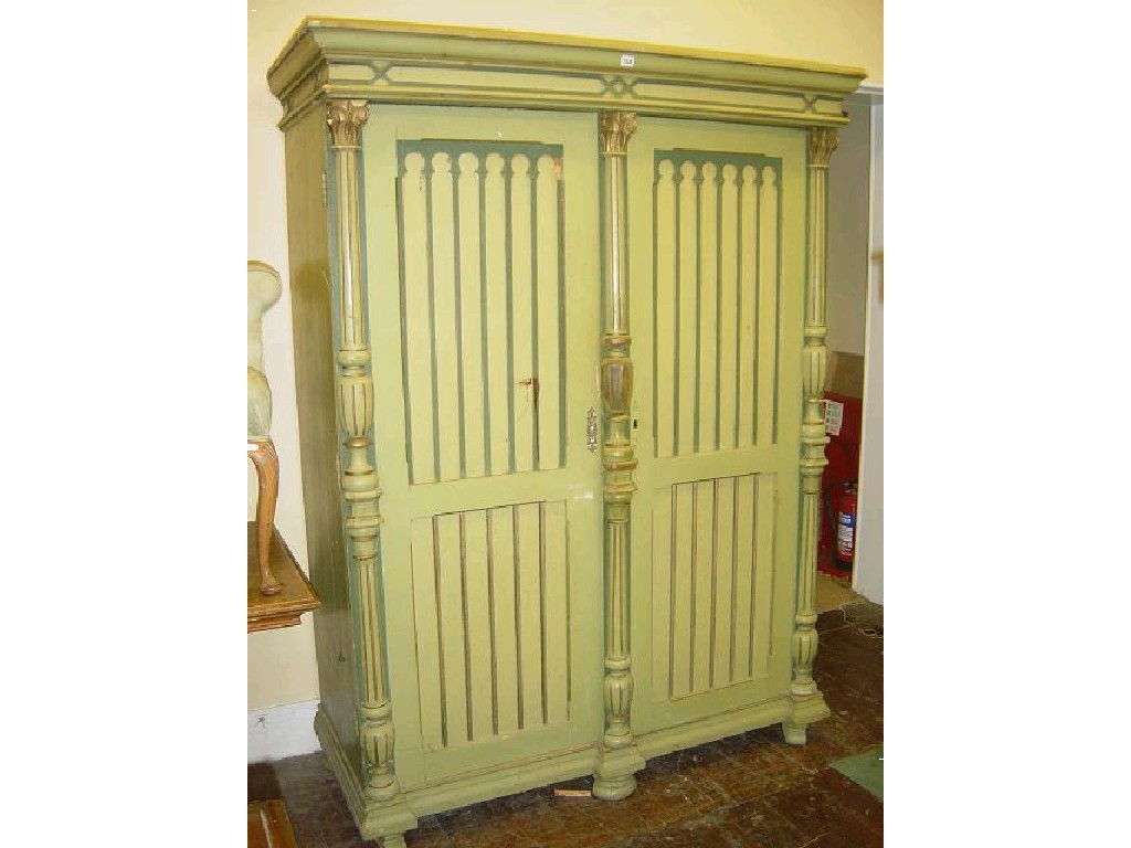 Appraisal: A continental painted pine wardrobe enclosed by a pair of